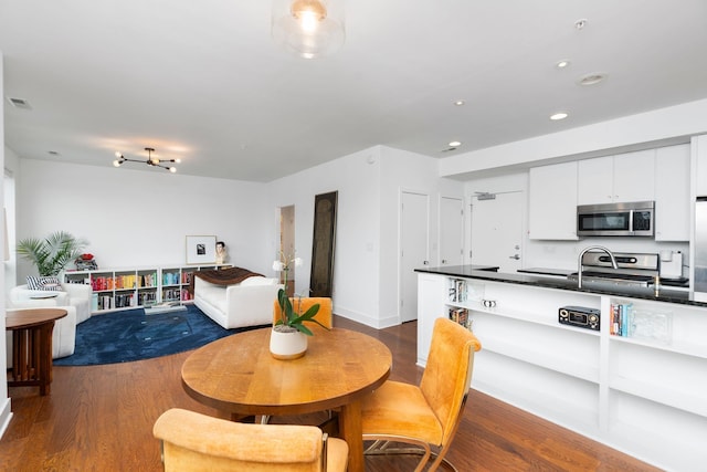 dining room featuring recessed lighting, wood finished floors, and visible vents