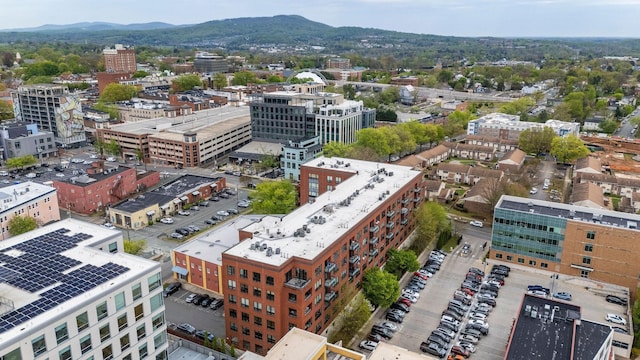 drone / aerial view featuring a city view and a mountain view