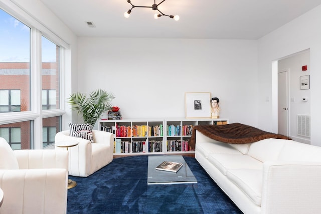 living area with visible vents and an inviting chandelier