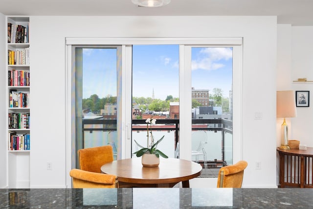 dining room featuring baseboards and built in features