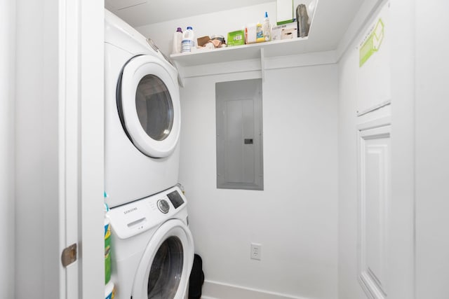 laundry room featuring stacked washing maching and dryer, electric panel, and laundry area
