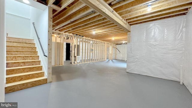 unfinished basement featuring stairway