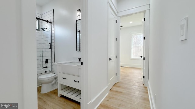 full bathroom with bathtub / shower combination, vanity, toilet, and wood finished floors