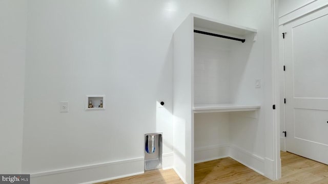 washroom with washer hookup and light hardwood / wood-style floors