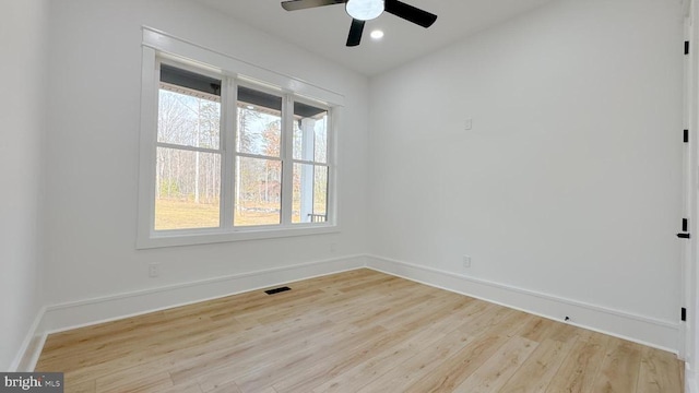 spare room with light wood finished floors, recessed lighting, visible vents, and baseboards