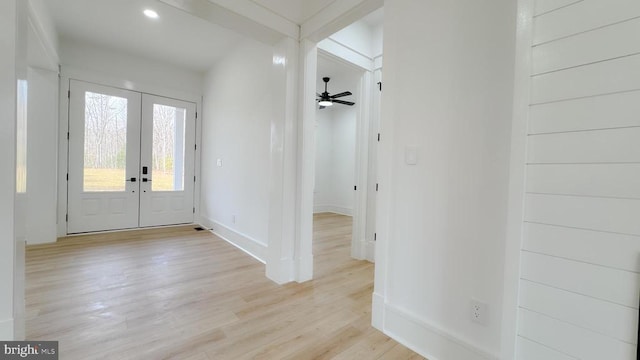 entryway featuring french doors, ceiling fan, and light hardwood / wood-style flooring