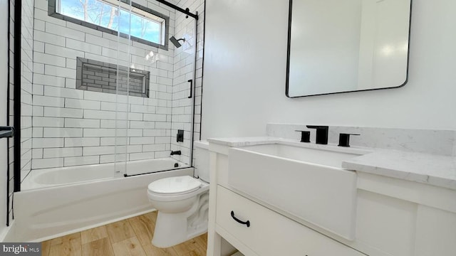 full bathroom with vanity, bathing tub / shower combination, wood finished floors, and toilet