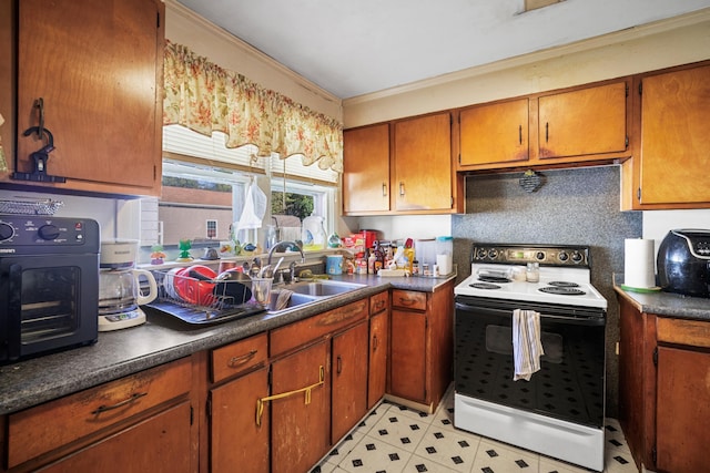 kitchen featuring dark countertops, electric range oven, ornamental molding, brown cabinets, and a sink