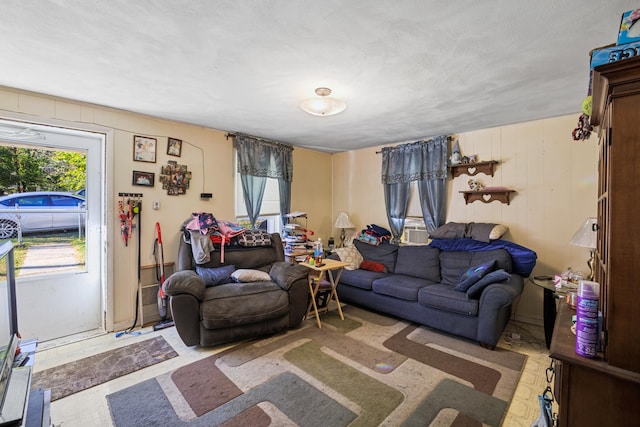 living room featuring a wealth of natural light and cooling unit