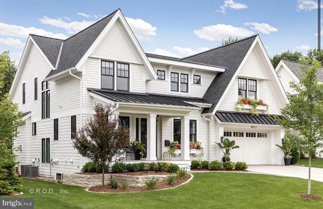 modern farmhouse with a garage, central AC unit, covered porch, and a front yard