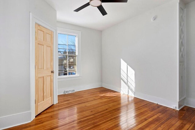 unfurnished room with hardwood / wood-style flooring and ceiling fan