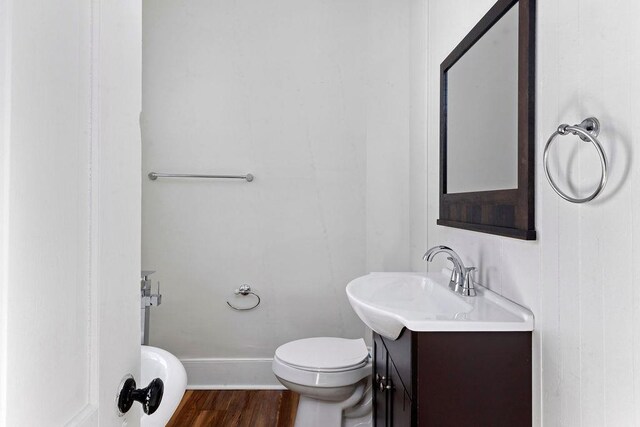 bathroom with vanity, hardwood / wood-style floors, and toilet