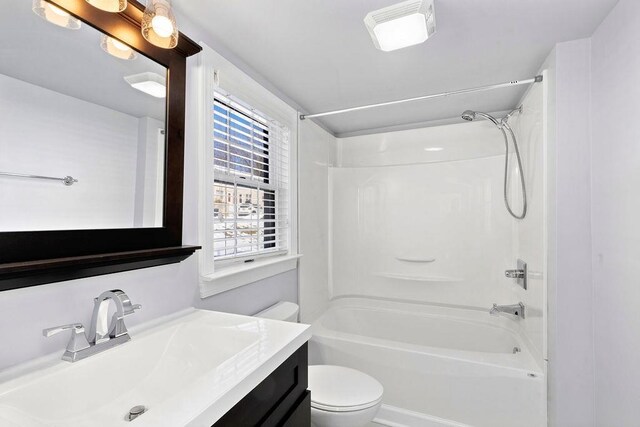 full bathroom featuring shower / washtub combination, vanity, and toilet