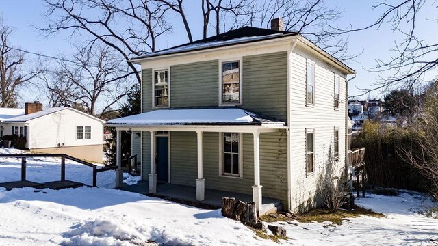 view of property featuring covered porch