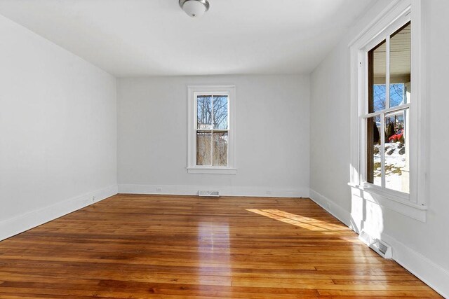 empty room with hardwood / wood-style flooring