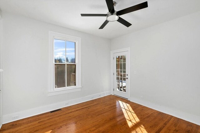 empty room with wood-type flooring and ceiling fan