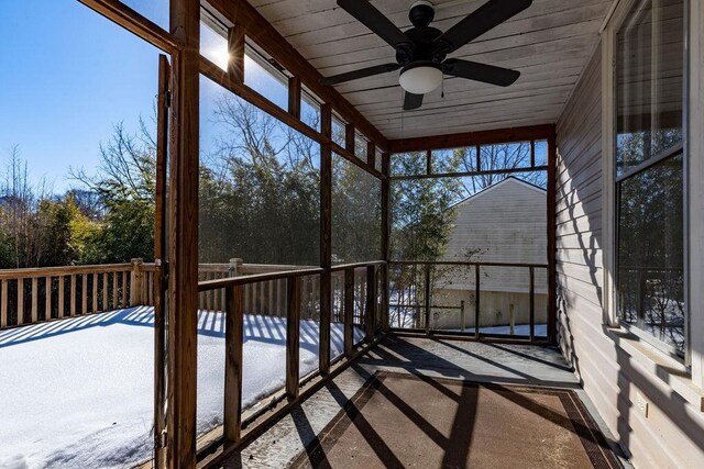 unfurnished sunroom with ceiling fan and wood ceiling