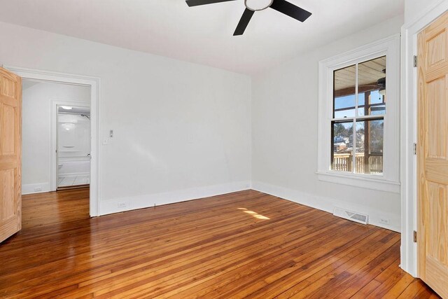 spare room featuring hardwood / wood-style floors and ceiling fan