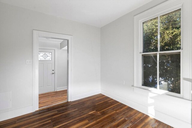 empty room with dark hardwood / wood-style floors