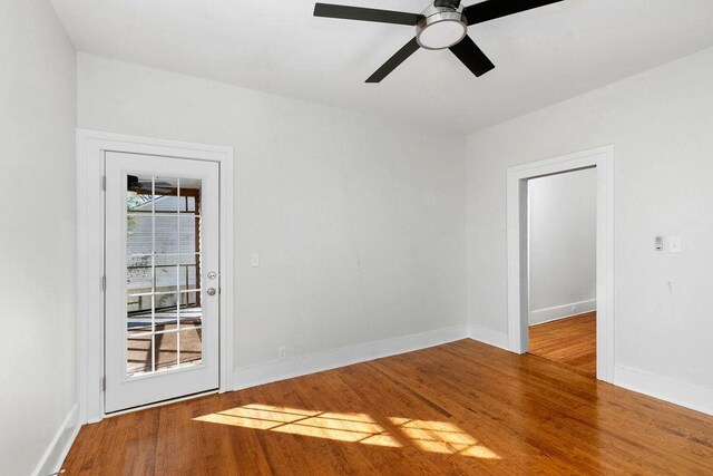 empty room featuring hardwood / wood-style floors and ceiling fan