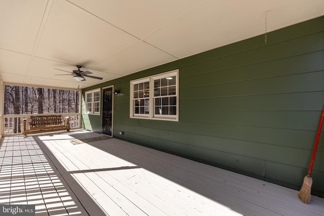 wooden deck with a ceiling fan