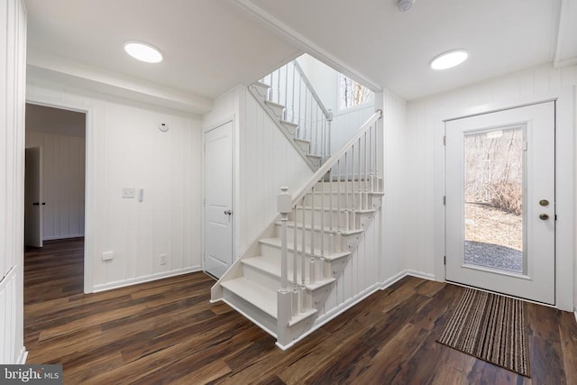 stairs featuring wood finished floors