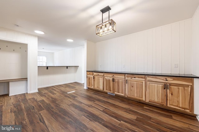 empty room with dark wood-style floors and recessed lighting