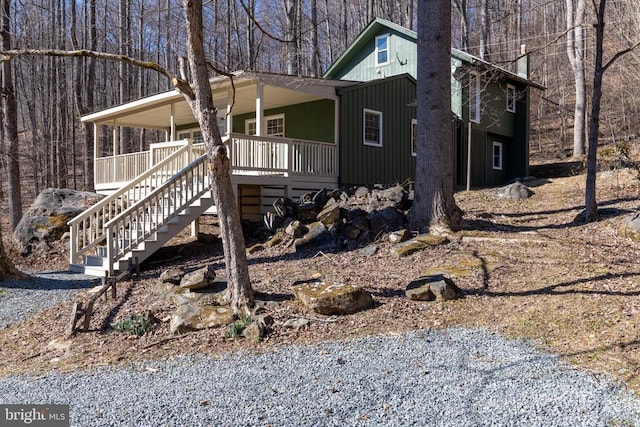 exterior space featuring covered porch and stairway