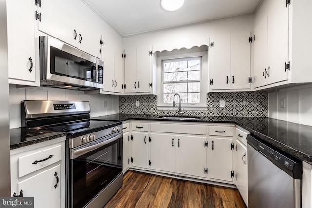 kitchen featuring stainless steel appliances, white cabinetry, and a sink