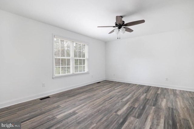 unfurnished room featuring dark wood-type flooring and ceiling fan