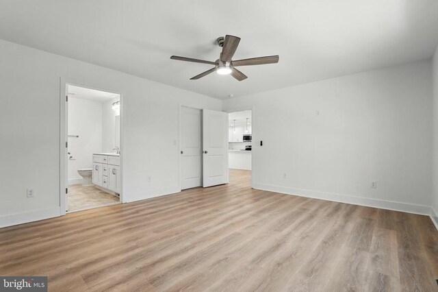 unfurnished room with dark wood-style floors, a ceiling fan, visible vents, and baseboards