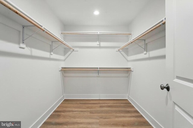 spare room featuring a ceiling fan, baseboards, and wood finished floors