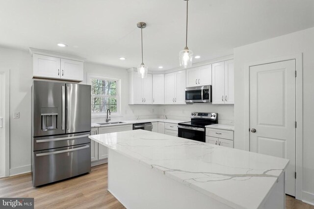 laundry area with laundry area, visible vents, baseboards, wood finished floors, and washing machine and dryer