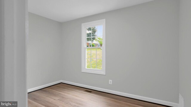 spare room with light hardwood / wood-style flooring