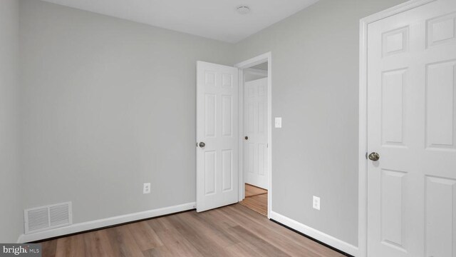 unfurnished bedroom with light wood-type flooring