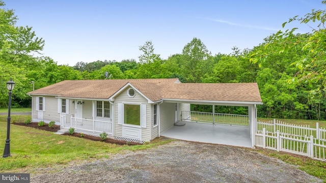 ranch-style home with a front yard, a carport, and a porch