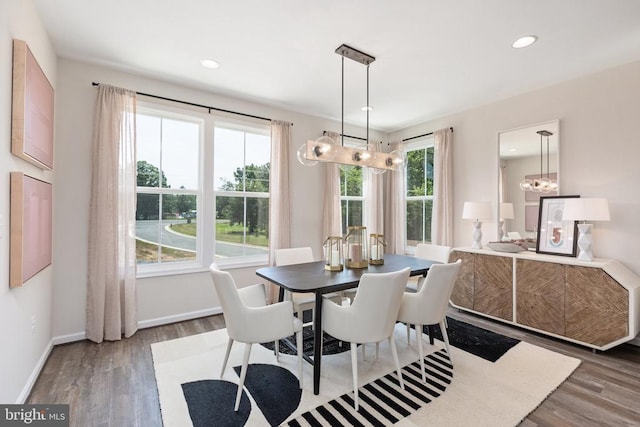 dining area featuring an inviting chandelier and dark wood-type flooring