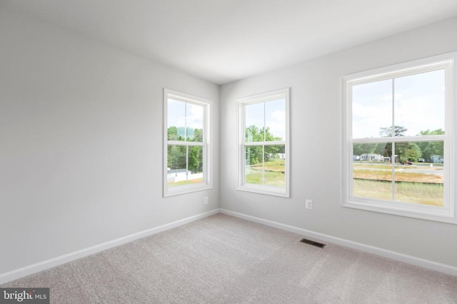 unfurnished room featuring carpet