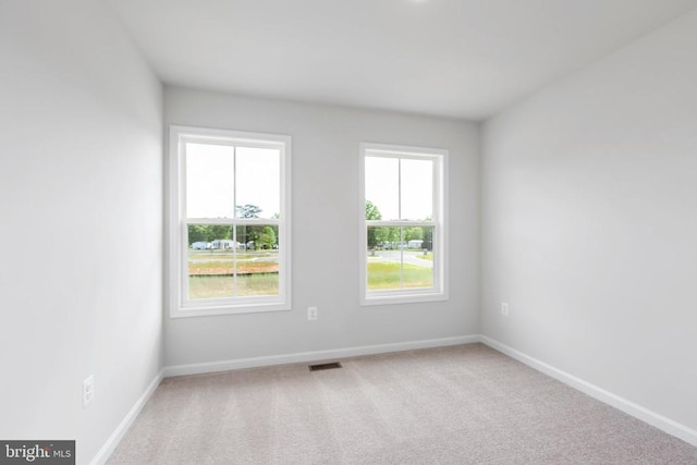 unfurnished room with light carpet