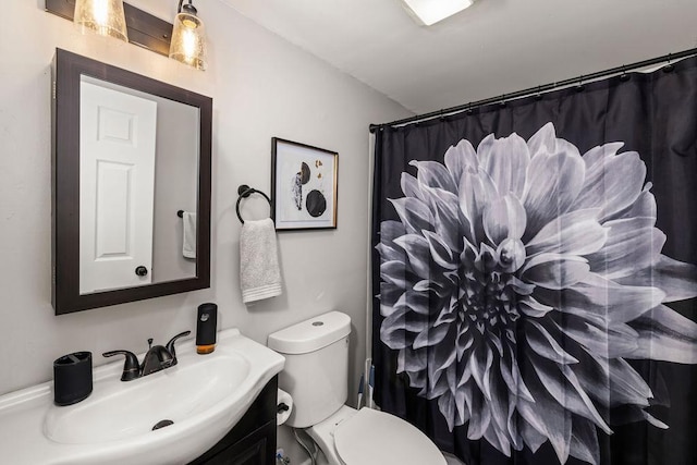 bathroom featuring vanity, curtained shower, and toilet