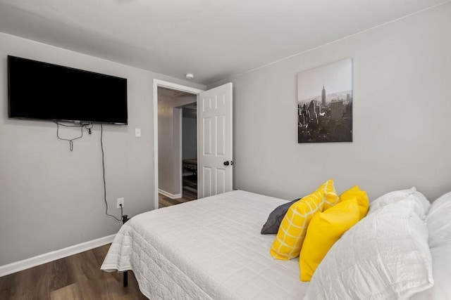 bedroom with dark hardwood / wood-style floors