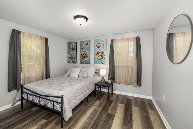 bedroom with dark wood-type flooring