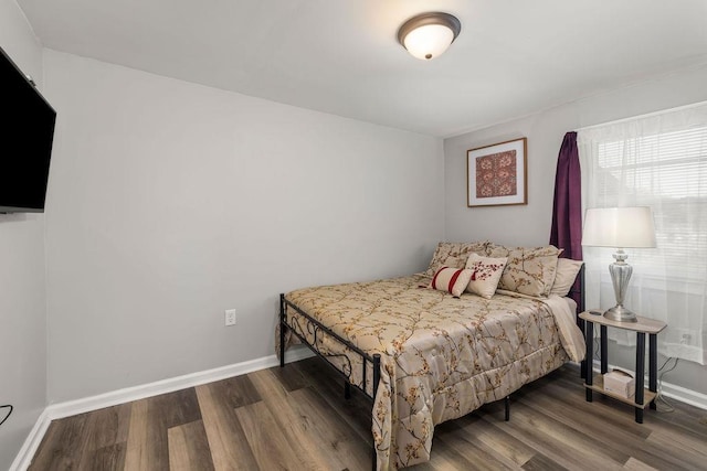 bedroom featuring dark hardwood / wood-style flooring