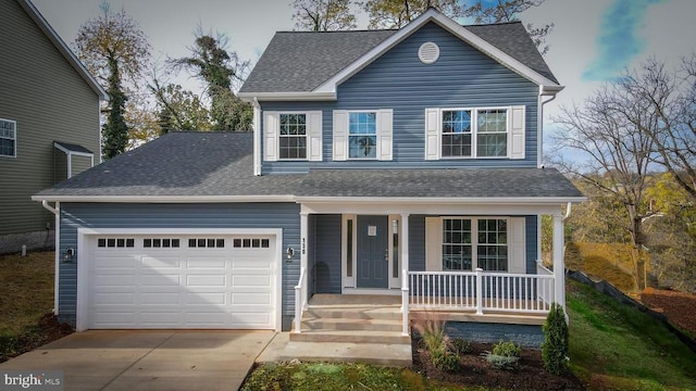 traditional home with a shingled roof, an attached garage, concrete driveway, and a porch