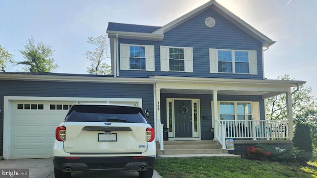 view of front facade featuring a garage, concrete driveway, and a porch