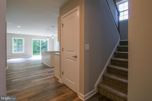 staircase featuring recessed lighting, baseboards, and wood finished floors