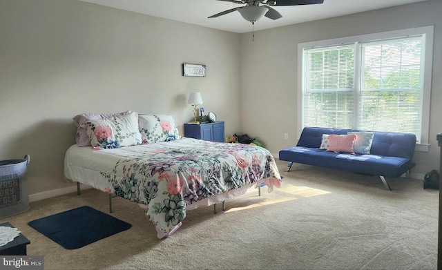 carpeted bedroom with baseboards and a ceiling fan