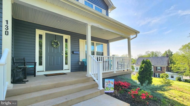 view of exterior entry with covered porch
