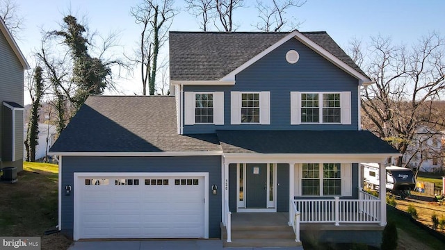 traditional-style home with a shingled roof, an attached garage, a porch, and driveway