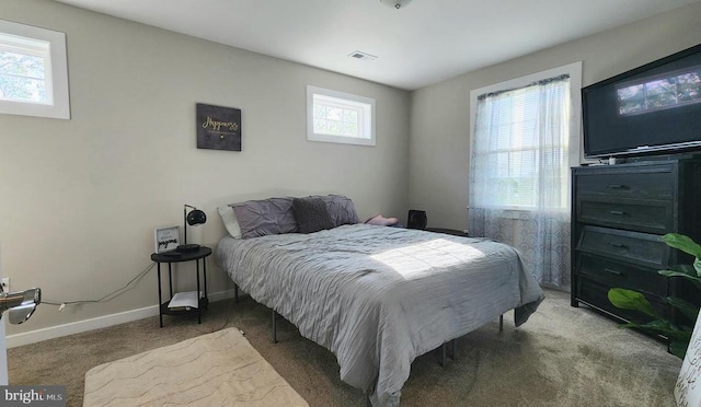 bedroom featuring carpet flooring, baseboards, and visible vents
